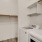 Laundry room at our apartments in Addison, featuring wood grain floor paneling and in unit washer and dryers.